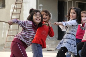 On 16 November, displaced children participating in UNICEF-supported psychosocial activities play tug of war, in a shelter in the city of Homs, capital of Homs Governorate. The humanitarian situation throughout Homs continues to deteriorate, with many areas experiencing daily shelling and fighting. On 16 November 2013 in the Syrian Arab Republic, 9.3 million people have been affected by the escalating conflict. Of these, 6.5 million people  over 2.9 million of them children  have been internally displaced. Syrians have also fled aoad, with more than 2.2 million people registered or awaiting registration with the United Nations High Commission for Refugees in Egypt, Iraq, Jordan, Lebanon and Turkey. Ongoing UNICEF initiatives inside the Syrian Arab Republic include the distribution of school bags with supplies to over 600,000 children; programmes in water, sanitation and hygiene; supporting the Ministry of Health in reaching children with medical check-ups and primary health care services via mobile medical teams and fixed centres; and the provision of psychosocial support services that are reaching more than 110,100 children. Following the confirmation of 13 cases of wild polio virus in the country, more than 1.2 million children have been vaccinated against the disease as part of an ongoing nationwide immunization campaign led by the Ministry of Health in coordination with UNICEF and the World Health Organization. Working with diverse governments, partners and other United Nations agencies, UNICEF has appealed for a total of US$470.65 million to cover responses within the Syrian Arab Republic and all host countries. By 14 November, nearly 87 per cent had been funded.