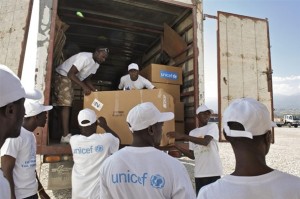 UNICEF and other workers load ECD kits onto a truck, at a UNICEF warehouse in Port-au-Prince, the capital. The supplies also include care packages for children, part of a UNICEF collaboration with the United States Fund for UNICEF and varied private sector partners. Both the ECD kits and the child care packages are destined for residential child care centres and UNICEF-supported child-friendly spaces for children affected by the earthquake. Some of the men wear T-shirts bearing the UNICEF logo. [#2 IN SEQUENCE OF NINE] On 5 Feuary 2010 in Haiti, UNICEF Early Childhood Development (ECD) kits are being distributed in Port-au-Prince, the capital, to residential child care and child-friendly' spaces that are providing services for children affected by the 12 January earthquake. The quake killed an estimated 112,000 people and left 1 million homeless. Major government and private infrastructure were destroyed or heavily damaged. In Port-au-Prince, as many as 460,000 people continue to live in makeshift settlements, despite an exodus of up to 482,000 from the devastated city. Each ECD kit, for use by up to 50 children aged 0-6 years, contains age-appropriate educational materials and learning tools to help caregivers provide a range of activities that encourage child development and social interaction. Materials include art supplies, hand puppets for story-telling, puzzle blocks and memory games, as well as water containers and soap to promote proper hygiene. UNICEF created the kit to help support the development and learning of children aged 0-6 years who are affected by emergencies. This distribution is one of the first in a plan to provide 1,000 kits to centres serving small children affected by the quake.