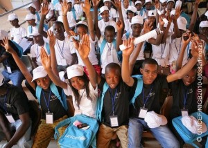 26 November 2010, children wearing UNICEF caps and T-shirts raise their hands at the closing ceremony of the National Youth Forum on Children's Rights that took place at the Djado Sekou Cultural Centre in Niamey, the capital of Niger. Child participation in decision-making processes is still a myth in Niger but some noteworthy progress are being achieved thanks to the myriad of efforts undertaken by UNICEF and partners to boost children's expression. Children's viewpoints on matters that concern them can contribute to the creation of a child-friendly environment respectful of their rights in Niger. In Niger more than 9 out of 10 children are deprived of at least one right essential to their well-being, and almost 8 in 10 children are deprived of at least two essential rights simultaneously. UNICEF Niger creates communication platforms that provide space for children to freely express themselves and by advocating for more airtime on radio and television to oadcast shows produced by and for children. At the end of 2010 UNICEF Niger organized a mega children's forum (November 24-26, 2010) inging together 160 children coming from the country's 36 districts. The forum gave children the unique opportunity to speak out and voice their concerns directly to national authorities, researchers, journalists and UN staff. Children's messages were oadcast on television and radio stations on a daily basis during and after the presidential election in 2010.