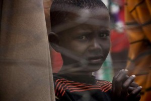 A Somali boy waits to register for food and other aid in the Dagahaley refugee camp in North Eastern Province, near the Kenya-Somalia border. The camp is among three that comprise the Dadaab camps, located on the outskirts of the town of Dadaab in Garissa District.  In early July 2011, Kenya, Somalia and Ethiopia are the three Horn of Africa countries most affected by a deepening drought, rising food prices and the persistent conflict in Somalia. More than 10 million people, including in neighbouring Djibouti and Uganda, are now threatened by the worst drought in the region in 60 years. Somalia faces one of the most-severe food security crises in the world as it continues to endure an extended humanitarian emergency, with tens of thousands fleeing into Kenya and Ethiopia. More than 10,000 Somalis a week are now arriving in the Dadaab camps in eastern Kenya, where aid partners struggle to meet the needs of some 360,000 people, in facilities meant for 90,000. An estimated 480,000 severely malnourished children are at risk of dying in drought-affected areas of Kenya, Somalia, Ethiopia and Djibouti; while a further 1.6 million moderately malnourished children and the wider-affected population are at high risk of disease. In northern Kenya, more than 25 per cent of children suffer from global acute malnutrition  in the Turkana district the rate is at 37.4 per cent, its highest ever. UNICEF, together with Governments, UN, NGO and community partners, is supporting a range of interventions and essential services, especially for the displaced and for refugees, including feeding programmes, immunization campaigns, health outreach, and access to safe water and to improve sanitation. An updated UNICEF Humanitarian Action Update is being issued to address scaled-up funding needs for the coming three months.