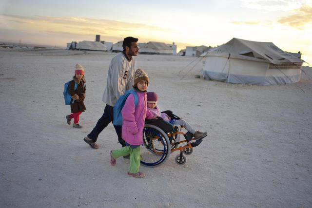 On 26 November 2013 in Jordan, Ahmed pushes his daughter Safa, 6, to school in a wheelchair, in the Zaatari refugee camp, in Mafraq Governorate, near the Syrian border. Two of Safas sisters are nearby. After the familys home in the Syrian city of Aleppo was destroyed, Safa, her parents, grandmother and five siblings fled to rural Damascus. While sheltering in an abandoned farmhouse, the family was caught in an attack that left Safa gravely injured  she lost her right leg and suffered burns and shrapnel wounds. She and her family now live in Zaatari, where Safa attends school in the mornings, goes to a child-friendly space in the afternoons and also regularly receives physiotherapy. I love my girls so much, says Ahmed. Im not with any side. Whats the fault of our daughters? Theyre not guilty. Why would this happen? As the Syrian crisis enters its fourth year, needs are escalating at an increasingly urgent pace, with children bearing the greatest toll. Since March 2011, over 7,000 children have lost their lives in the violence, while hundreds of thousands have been wounded, some of whom must now live with life-long disabilities caused by their injuries. By mid-December 2013, the conflict had left 6.5 million people displaced internally. They are among 9.3 million people inside the country in need of humanitarian assistance, of whom 46 per cent are children. Fighting has also forced over 2.2 million people to seek refuge aoad. The majority have fled to Egypt (130,524 refugees); Iraq (210,612); Jordan (568,501); Lebanon (787,886); and Turkey (553,281). The decimation of medical facilities, immunization and cold chain systems, and water, sanitation and hygiene infrastructure has jeopardized childrens health and markedly increased their vulnerability to diseases, which spread with greater ease amid mass population movements. In October 2013, cases of wild poliovirus were identified in the Syrian Arab Republic, where the disease ha