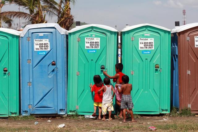 On 6 December, children stand outside portable toilets, in the Astrodome evacuation centre in Tacloban City  among the areas worst affected by Typhoon Haiyan  in Leyte Province, Eastern Visayas Region. The toilets bear the UNICEF logo. From 5 to 7 December in the Philippines, Government-led emergency relief and recovery operations continued in the wake of the destruction caused by Typhoon Haiyan (known locally as Yolanda), which hit the Philippines on 8 November. Casualties have reached 5,759, and 1,779 people remain missing. Some 15 million people, including 6.7 million children, have been affected. Some 4 million people, including 1.6 million children, have been displaced. The storm, one of the strongest ever to make landfall, also destroyed homes, schools, hospitals, roads, communications and other basic infrastructure, and damaged power and water supply systems. Though main roads were passable as of mid-November, deis continues to hamper access to remote areas. To date, UNICEF response has ensured that 360,500 people in affected areas have access to clean water. Hygiene kits have been provided to 100,000 people, and toilet slabs and portable toilets are serving 25,000 people. Other support includes screenings for malnutrition in children under age 5; efforts to reunify unaccompanied and separated children with their families; the establishment of temporary learning spaces that have benefitted over 10,000 children; and the assessment of damage to the cold chain in affected areas. UNICEF has appealed for US$61.5 million to cover its response to Typhoon Haiyan through May 2014.