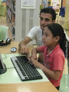 Childs View A man teaches computer skills to a girl at the Al Qattan Centre for the Child in Gaza City, in the Gaza Strip. The photograph was taken by Hedab Abu-Rass, 18, one of 19 participants in a UNICEF-organized child photography workshop. In August 2009 in the Occupied Palestinian Territory (OPT), UNICEF held photography workshops for children in both the West Bank and the Gaza Strip. The workshops overarching theme was child rights, part of global tributes to the 20th anniversary of the Convention on the Rights of the Child on 20 November of this year. In the Gaza Strip, the workshop was held in Gaza City with 19 young people, aged 12-19, at the Al Qattan Centre for the Child, a local UNICEF-assisted cultural and educational NGO. Guided by UNICEF photographer Giacomo Pirozzi, participants selected their own topics to photograph, including: examples of the local culture and industry; health and leisure activities; activities at the Al Qattan Centre; and the continuing impact of the December 2008-January 2009 Israeli military incursion into Gaza. The conflict killed 1,300 Gazans, including 350 children, and destroyed much of the infrastructure. Rebuilding has been severely constrained by an economic embargo, in effect since 2007, that blocks critical materials from entering the Strip and has left 80 per cent of its refugees dependent on food assistance from the United Nations Relief and Works Agency (UNRWA), the largest provider of humanitarian assistance in the territory.