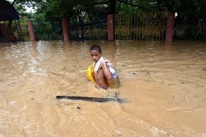 A boy carries supplies through waist-high floodwater in Pasig City in Manila, the capital. On 30 September 2009 in the Philippines, over half a million people are displaced by flooding caused by Tropical Storm Ketsana (also known as Ondoy), which struck on 26 September. The storm dumped over a months worth of rain on the island of Luzon in only 12 hours. The flooding has affected some 1.8 million people, and the death toll has climbed to 246; both numbers are expected to rise as aid workers reach additional disaster areas. The Government has declared a state of calamity in Metropolitan Manila the capital city with a population of over 15 million and 25 other provinces. Power outages and mud-choked roads are slowing rescue efforts, and shelters report shortages of food, medicine and other essential supplies. Stagnant floodwater poses disease and sanitation hazards, and two other tropical storms are approaching the country, complicating relief efforts. UNICEF has responded by distributing hygiene kits, essential medicines, water purification tablets, portable toilets, blankets and soap, and is collaborating with the relief efforts of other UN agencies. UNICEF is also working to address the long-term needs of affected children by providing psychosocial support and planning for the rehabilitation of damaged schools.