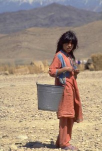 A girl carries a metal pail along the rocky terrain of the UNICEF-assisted Sarshahi camp for displaced persons near the city of Jalalabad in the eastern province of Nangarhar. Because the camp is located on dry rocky land, water must be ought in by truck or collected from a nearby canal and then treated with chlorine to make it safe for drinking. In 1994 in Afghanistan, civil conflict -- now in its 15th year -- has destroyed the country's economy and infrastructure. Already one of the world's poorest countries before the war, the situation has become dismal. Some one million people are dead and twice that number are injured or disabled. Over 500,000 women have been widowed. A third of the population has become refugees and some two million people have been internally displaced. UNICEF-assisted programmes focus on the immediate needs of the country's most vulnerable, including displaced populations and children in especially difficult circumstances, by providing basic health care, sanitation, safe water and vaccinations.