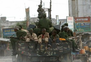 On 11 January, Transitional Federal Government (TFG) soldiers patrol the streets of Mogadishu, the capital. A boy (right foreground) accompanies them. Following several days of fighting the city is relatively peaceful although there is sporadic gunfire.  By 11 January 2007 in Somalia, renewed conflict has deepened the crisis for children and women who are already suffering from successive droughts and flooding in the last two years, as well as from resurgent wars that began in 1991. Children are being recruited and forced to fight by all parties to the conflict and increased numbers of people are being displaced. Together with the psychological trauma of war for children, they are also now at even greater risk of disease while access by humanitarian agencies to the vulnerable is more difficult. Children and women are being killed and wounded in the violence, some children have been separated from their families and school attendance has plummeted. Over two million Somalis, or one-quarter of the population, have already been affected by the 2005-2006 drought and subsequent flooding. The country has little infrastructure and fewer than 20 per cent of school-age children attend primary school. Maternal mortality is among the highest in the world and the under-five mortality rate is 156/1000.