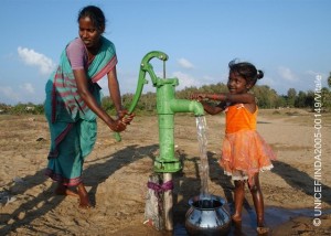 MUDTUKADU, CHENNAI, TAMIL NADU, INDIA January 4th 2005: Suni stands near the handpump watching water being filled by a woman in a pot. Villagers who lost their home by the deadly tsunami, live in tents and rely on aid for their survival in the village near a seashore. The destruction and the devastation that the tsunami struck in the villages along the seaside was very tragic. Many lost their home and livelihood after tsunami ravaged the coast of India and Southern Asia. Leaving over 1,50,000 people dead, more than 15,000 in India alone and rendered many people homeless. Officials say that trauma is one of the biggest health concerns for the survivors of this tragedy. UNICEF partnered with the government and NGOs to mobilise communities in relief camps. PHOTO CREDIT : UNICEF / INDIA / AMI VITALE Keywords: Natural disaster, tidal waves Mudtukadu, Tamil Nadu, India Tsunami victims India