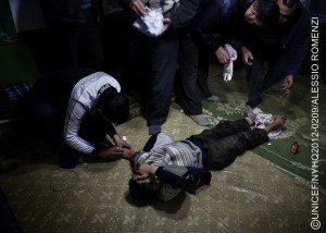 In late January, a boy receives first aid after being shot in the foot by a sniper, in a town affected by the conflict. In January and Feuary 2012 in Syria, children found themselves in the midst of a growing conflict between rebel and government forces. By mid-March, violence had claimed the lives of more than 500 children and 244 women. By late March, the year-long conflict had killed 9,000 people and wounded many others. An estimated 1.7 million people have been affected by the violence, which has extended into at least half of the countrys 14 governorates. Education and health services have also been disrupted. Some 150,000200,000 people have been internally displaced. An estimated 30,000 refugees  half of them children  have fled to Turkey, Lebanon and Jordan. While most have registered with the United Nations High Commissioner for Refugees (UNHCR), others have not, fearing possible retaliation against them or family members remaining in Syria. Many refugees in Lebanon and Jordan are being hosted by local families, who also require assistance. UNICEF is participating in an inter-agency assessment of needs in conflict-affected parts of Syria and has requested US$7.4 million to  with governments, UNHCR and local and international NGOs  address the needs of an anticipated total of 40,000 refugee children, including those staying with host families, in Jordan, Lebanon and Turkey, over the next six months. Support includes psychosocial assistance for children traumatized by the conflict to which they have been subjected or borne witness.