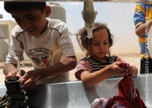 Children wash clothes, in Zaatari, a tented camp for Syrian refugees, on the outskirts of Mafraq, capital of the northern Mafraq Governorate. UNICEF assistance in the camp includes the provision of safe drinking water and the installation of permanent latrines, bathing facilities, wash basins, as well as mobile units containing these amenities. UNICEF also supports a child-friendly space, run by Save the Children. By late July 2012, Jordan was hosting 37,380 refugees from Syrias escalating war. Syrians have also fled to nearby Iraq, Lebanon and Turkey, inging the total number of refugees to over 120,000  half of them children. Inside Syria, an estimated 1.5 million people are in need of humanitarian assistance. Deaths, including of children and women, have surpassed 17,000. In Jordan, the number of refugees continues to increase, straining already limited resources in crowded accommodation facilities. Four transit sites in northern parts of the country are hosting nearly 5,200 refugees, though their intended capacity is less than half that. Zaatari, a UNICEF-assisted tented camp, has been newly built to accommodate over 100,000 refugees. UNICEF is working with diverse governments, the United Nations High Commission for Refugees (UNHCR) and local and international NGOs to respond to the needs of affected children in Jordan, other host countries and inside Syria. UNICEF also supports initiatives in education, water, sanitation and hygiene and child protection, including psychosocial assistance for children traumatized by their experiences in relation to the conflict. To fund this work, UNICEF has requested US$39.2 million, of which only 30 per cent has been received to date.