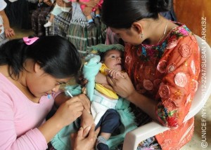 (Right) Alba Flor Bol, an indigenous Mayan woman, holds her 3-month-old daughter, Esteyner Leandrinho Chen, as health worker Lourdes Rodriguez administers a pentavalent vaccination, at a health centre in the community of Corosal in Cobán Municipality, in Alta Verapaz Department. The pentavalent vaccine protects against five common diseases: diphtheria, tetanus, pertussis (whooping cough), hepatitis B and Haemophilus influenza type b (also called Hib, a cause of pneumonia and meningitis). The centre, which is open once a month, serves a population of 1,000, and is run by the Ministry of Health with support from UNICEF. Volunteer health workers provide routine health care and immunizations for pregnant women and children under 5 in five surrounding communities. [#3 IN SEQUENCE OF THREE]  In November 2012 in Guatemala, the Government and other partners are continuing to assure sustained routine immunization of children  now reaching 92 per cent of all infants  against a range of vaccine-preventable diseases. The countrys last endemic case of measles was in 1997. In the entire Americas Region (covering North, Central and South America), the last endemic measles case was in 2002 and the last endemic case of rubella was in 2009  part of global efforts to eradicate these diseases. Worldwide, measles remains a leading cause of death among young children: In 2010, an estimated 139,300 people  mainly children under the age of 5  died from the disease. Nevertheless, these deaths decreased by 71 per cent from 2001 to 2011, thanks in part to the Measles & Rubella Initiative, a global partnership led by the American Red Cross, the United Nations Foundation, the United States Centers for Disease Control and Prevention (CDC), WHO and UNICEF. In Guatemala, despite this success, significant other challenges for children remain, much of it related to poverty levels that affect more than half of all children and adolescents. Poverty also contributes to chronic malnutrition affecting half of all under-5 children (with higher rates among indigenous populations); an average national education level of under six years of primary school (under three years for the rural poor); and high, though decreasing, rates of violence. Guatemala is also one of the worlds most vulnerable countries to climate change, suffering a major climate-related emergency every year since 2008. On the positive side, birth registration is improving, with more than 95 per cent of newborns now being registered. UNICEF is working with the Government and other partners to sustain achievements in health, address the high levels of malnutrition, strengthen responses to crimes against children and increase protection services for children throughout public services.