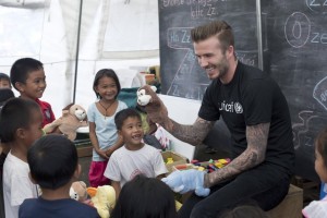 [ALL D.BECKHAM IMAGES ARE RESTRICTED. ALL UNICEF USE MUST BE CLEARED BY chloee@unicef.org.uk OR louiseo@unicef.org.uk] On 14 Feuary 2014 in the Philippines, UNICEF Goodwill Ambassador David Beckham and children play with puppets at a UNICEF-supported tented school in Tanauan  one of the areas hardest hit by Typhoon Haiyan. As a UNICEF Goodwill Ambassador, seeing how children are being given a sense of normality amidst the rubble of their communities has been amazing, he said. I want to show people around the world how their generous donations have had an enormous impact on children and their families and how thankful people here are for their kindness. Mr. Beckhams T-shirt bears the UNICEF logo.