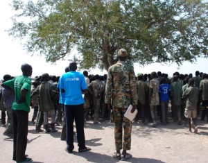 On 27 January, children leave a ceremony formalizing their release from the SSDA Coa Faction armed group, in the village of Gumuruk, Jonglei State. Earlier that day, the children surrendered their weapons and uniforms in a UNICEF-supported ceremony overseen by the South Sudan National Disarmament, Demobilization and Reintegration Commission and the Coa Faction. The T-shirt of a UNICEF worker bears the UNICEF logo. On 27 January 2015 in South Sudan, UNICEF and partners secured the release of approximately 3,000 children associated with an armed group, in one of the largest-ever such releases of children. The first group of 280 children were released today in the village of Gumuruk, Jonglei State. Releases of additional children will occur over the coming month. Recruited by the South Sudan Democratic Army (SSDA) Coa Faction, the children range in age from 11 to 17 years. Some have been fighting for up to four years, and many have never attended school. In the last year, 12,000 children, mostly boys, have been recruited and used as soldiers by armed forces and groups in South Sudan as a whole. The newly released children are being supported with basic health care, protection services and necessities such as food, water and clothing to help them prepare to return to their families. Counselling and other psychological support programmes are urgently being established. The children will soon have access to education and skills training. UNICEF is working to trace and reunify the children with their families, a daunting task in a country where more than 1 million children have either been displaced internally or have fled to neighbouring countries since fighting oke out in December 2013. Support will extend to local communities to prevent and reduce discrimination against the returning children and also to prevent possible recruitment. UNICEF estimates the costs for the release and reintegration of each child is approximately US$2,330 for 24 months. To date, UN