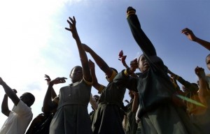 On 24 May, schoolchildren sing a song during the visit of UNICEF Executive Director Ann M. Veneman to Dvumbe Primary School, in a rural area south-east of Mbabane, capital of Swaziland. Some 30 per cent of children at the school have lost either one or both of their parents to AIDS. To help encourage orphaned and other vulnerable children to stay in school, UNICEF supported the creation of a vegetable garden at the school as well as a programme providing two nutritious meals a day. The meal programme is now being provided by the World Food Programme.  From 22 to 28 May 2005, UNICEF Executive Director Ann M. Veneman travelled to South Africa, Swaziland and Malawi to review the impact of HIV/AIDS on children, as well as UNICEF programmes. All three countries are highly affected by the pandemic, in a region that has the largest number of children in the world affected by HIV/AIDS and the highest percentage of children orphaned by AIDS. Swaziland and Malawi face the 'triple threat' of food insecurity, weakened governance and HIV/AIDS. During her trip, Ms. Veneman met with government officials, donor agencies and other UNICEF partners and visited hospitals and other health facilities, including sites providing services to prevent mother-to-child transmission of HIV; community outreach centres; schools; nutrition programmes; and a child-headed household. She also joined United Nations Special Envoy for Humanitarian Needs in Southern Africa James Morris (who is also World Food Programme Executive Director) and UNAIDS Executive Director Dr. Peter Piot to review joint UN programmes and resource needs to address these issues. This was Ms. Veneman's first official field visit as UNICEF Executive Director.