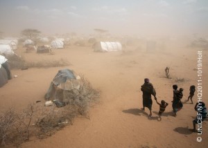 On 9 July, a woman and several children walk through a dust storm to their tent, in an area for new arrivals in the Dagahaley refugee camp in North Eastern Province, near the Kenya-Somalia border. The camp is among three that comprise the Dadaab camps, located near the town of Dadaab in Garissa District. On 26 August 2011, the crisis in the Horn of Africa affecting primarily Kenya, Somalia, Ethiopia and Djibouti continues, with a worsening drought, rising food prices and ongoing conflict in Somalia. Some 12.4 million people are threatened by the regions worst drought in 60 years. Hundreds of thousands of children are at imminent risk of dying, and over a million more are threatened by malnutrition and disease. In Kenya, 1.7 million children have been affected by the drought, including 220,000 Somali refugee children in the north-eastern town of Dadaab. UNICEF, together with the Government, United Nations, NGO and community partners, is supporting a range of interventions and essential services, especially for the displaced and for refugees, including feeding programmes, immunization campaigns, health outreach, and access to safe water and to improve sanitation. A joint United Nations appeal for humanitarian assistance for the region requires US $2.4 billion, of which 58 per cent has been received to date. A majority of UNICEFs portion of the appeal has been funded.