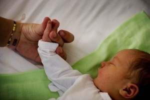 A woman holds the hand of her newborn at the KBC Zvezdara Maternity Hospital in Belgrade, the capital. A UNICEF-supported programme in the hospital teaches women how to care for their newborns, part of an effort to support families and prevent child institutionalization.  In June 2011 in Serbia, the proportion of children deprived of parental care is increasing, reflecting trends throughout Central and Eastern Europe and Central Asia. The region has the worlds greatest rate of children growing up in formal alternative care settings, which range from institutionalization to foster care. Some 1.3 million children in the region grow up in formal alternative care, including 626,000 children who live in residential institutions. While rates of child institutionalization in the region have remained stagnant, the overall placement of children in formal care is increasing, often a response to disability or poverty. And in Serbia, child institutionalization rates appear to be increasing, from 349 per 100,000 children in 2004 to 400 per 100,000 children in 2006. Still, Serbia is one of only two countries in the region to approve laws that prohibit the institutionalization of infants (the other is Romania). Institutional care for children under age three is known to be damaging to their mental and emotional development, inhibiting cognitive and speech development, impairing intelligence, and contributing to emotional detachment.  Serbia is also one of only four countries in the region to ratify the United Nations Convention on the Rights of Persons with Disabilities. Children with actual or perceived disabilities are at greater risk of being institutionalized and of being abused while in residential care. UNICEF urges Governments throughout Central and Eastern Europe and Central Asia to immediately end the institutionalization of children under age three, to allocate resources to support vulnerable families, to provide alternative services for children with disabilities, and to make the needs and rights of the youngest children a priority in policymaking.