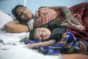 Village: TIDI, Block: Girwa, District: Udaipur, Rajasthan, India. September 6, 2012.   A two day old child sleeps next to its mother at a maternity ward of the Primary Health Care Center (PHC) in Tidi.  Members of IKEA Foundation and UNICEF delegation visit a Primary Health Centre (PHC), Tidi.  The delegation interacted with doctors, staff and patients, observing essential and critical maternal and child survival interventions getting closer to remote families and communities.  They were exposed to the various services like Ante-Natal Care services, labour room, newborn care unit, Pre Natal Care services available at the center.   The IKEA Foundation team along with UNICEF visit the field to see some of its projects related to Sunnan lamps, cotton projects and child survival in rural Rajasthan. The IKEA Foundation has supported UNICEF programs for more than a decade and has a corporate partnership with IKEA, working at an international and local level. â??By working together for the past 10 years, and contributing more than â?¬100 million ($125 million US*) to UNICEF projects in India so far, we have created opportunities for more than 74 million children,â? explained Per Heggenes, CEO at IKEA Foundation. â??By thinking long-term and teaming-up with UNICEF, weâ??re giving hope to many millions of families.â? UNICEF India/2012/ Prashanth Vishwanathan