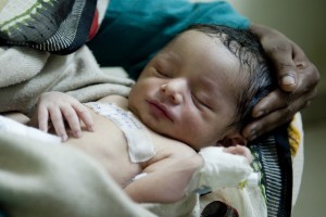 Rekha Verma holds her four days old son in the feeding room of the Sick New-Born Care Unit (SNCU at the district hospital Guna, Madhya Pradesh. Despite being one of the most mineral rich states in India, with vast hoards of diamonds, Madhya Pradesh is one of the poorest with 40% of its population living in poverty. The state also has some of the worst development statistics in India. Of every 1000 births in Madhya Pradesh - 310 mothers will die, while 59 new-borns will die for every 1000 live births - one of the highest infant mortality rates in the country, and compares starkly with Kerala for example where 14 infant will die out of 1000 births. This number jumps to 63 newborn deaths for every 1000 live births in rural areas. UNICEF India/ 2013/ Manpreet Romana