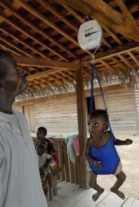 A health worker weighs a girl toddler in a sling-scale in the town of Bétou in the northern Likouala Province. The growth-monitoring activity is part of health and nutrition interventions being provided in the area by the Italian logging concession Likouala Timber. The company, which has concessions for 525,000 hectares of forest land, provides therapeutic food and other health and nutritional services for sick and malnourished children, as well as maternal and general health information. It also supports a skills-training project for young people. An estimated 10,000 people live in the riverside town. In May 2009 in the Republic of the Congo, about half of the countrys 3.7 million people continue to live in poverty, and a large portion of inhabitants more than half of them children remain without basic social services. Despite progress in the areas of health, nutrition, education and basic child protection, access to safe water and sanitation is lacking, and malnutrition and disease remain chronic and widespread. Conflict in the neighbouring Democratic Republic of Congo has also resulted in an influx of refugees into Likouala Province, a remote northern region comprised primarily of indigenous forest. Likouala, which also shares borders with Cameroon and the Central African Republic, is one of the countrys poorest and least-developed areas, with an estimated 165,000295,000 inhabitants who are mostly local Bantu and indigenous Baka. Semi-nomadic hunter-gatherers, the Baka, who represent about 10 per cent of the overall population, live mainly in and around the forest and continue to face widespread discrimination. The destruction of large parts of their natural habitat (from logging, poaching and illegal cultivation) also threatens their way of life. Working with the Government, local authorities, NGOs and other partners, UNICEF supports health, nutrition, water and sanitation, education, protection and other interventions, including in hard-to-access communities; and also advocates to promote indigenous as well as other child rights.