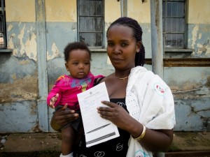 A happy mother displays her child's short birth certificate generated by Mobile Vital Records System (Mobile VRS), at Mulago hospital. At the hospital, birth registration is done using Mobile Vital Records System (Mobile VRS) an innovative technology supported by UNICEF to improve birth registration in Uganda.   This was part of the activities during the Uganda Pan African Study Tour Conference under the theme, Breaking with oken systems .    The purpose of Uganda Pan-African Study Tour, is to enable government counterparts from countries implementing the above project and members of the Africa Programme on Accelerated Improvement of Civil Registration and Vital Statistics (APAI-CRVS) Core Group to share and learn from each otherÕs innovations in improving national civil registration and vital statistics.