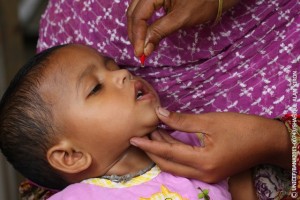 29 May 2011: A child is administered a dosage of  vitamin A from a red capsule at  Bharashakati Government Primary School, Ujirpur, during the UNICEF supported  National Vitamin A Plus Campaign, NVAC in Barisal.      The National Vitamin A Plus Campaign (NVAC) has been running for almost a decade and is one of the biggest in Bangladesh. In 2010, more than 95 per cent of children aged 12 to 59 months received Vitamin A supplementation and more than 93 per cent infants aged 9 to 11 months received Vitamin A supplementation. In 2011, as part of a new trial, infants aged six to eight months are eligible to receive the vaccination in seven districts. 900,000 infants between six and eight months were targeted during the one-day campaign. In the years prior, infants aged nine to 11 months received the vaccine as part of a wider immunization campaign against measles but following recommendations by the World Health Organisation, it was decided those aged between six and 59 months were to receive the vaccination as part of the specific Vitamin A campaign.  Bangladesh has a poor dietary intake of Vitamin A and less than 40 per cent of pregnant and lactating women receive enough Vitamin A as part of their diets. The supplement protects against night blindness, helps cells function, aids the production of protective red blood cells and boosts the bodys immune system. Because the campaign also aims to increase awareness around Vitamin A, more than 400,000 volunteers and 60,000 health service providers across Bangladesh assisted in getting people to distribution points, administering the droplets and disseminating information about the importance of Vitamin A and healthy living. Messages had been oadcast on television and radio as well as through megaphones attached to the back of moving vehicles. Posters were hung around villages and mosques delivered information to worshippers. Since 1997, the prevalence of night blindness in children has been maintained below the 1% threshold that signals a public health problem but on-going support is needed. The NVAC campaign targeting infants from six months is expected to run bi-annually for the next three years. It is being implemented by the Institute of Public Health Nutrition (IPHN), under the Ministry of Health and Family Welfare, in collaboration with the Expanded Programme on Immunization (EPI) and Primary Health Care. It is supported by UNICEF, the Micronutrient Initiative and WHO.