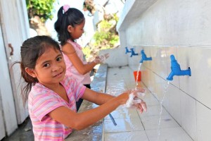 On 3 Feuary, (foreground) Grade 2 student Venus Mueva, 8, washes her hands with soap and water at a new hand-washing facility after using the latrine, at Santo Niño Elementary School in the town of Tanauan  one of the areas hardest hit by Super Typhoon Haiyan  in Leyte Province, Eastern Visayas Region. Her school, which reopened on 8 January, was badly damaged by the storm. Classes are now being held in tents and makeshift or repaired classrooms. UNICEF has provided tents, educational supplies, latrines and hand-washing facilities at the school and is also supporting teacher training. Many of the students lost family members and other relatives during the disaster, and most have lost their homes and belongings. Venuss 4-year-old sister, Viana, was swept away during the storm. Her home was also destroyed. She and her parents now live in a temporary shelter located just a few metres from the school. In early Feuary 2014 in the Philippines, Government-led relief operations continue following the destruction caused by Typhoon Haiyan, which hit the country on 8 November. The typhoon, known locally as Yolanda, was one of the strongest to ever to make landfall. More than 6,200 people have been killed in the disaster and 1,785 are missing. The storm also destroyed homes, schools, hospitals, roads, communications and other basic infrastructure, and damaged power and water supply systems. An estimated 14.1 million people, including more than 5.9 million children, have been affected; and, three months after the massive storm, 4.1 million people, including over 1.7 million children, remain displaced. Many of the displaced are still living in damaged or makeshift dwellings, temporary tents and evacuation centres. In response to the emergency, UNICEF has delivered 100 tons of relief supplies for typhoon-affected communities, including emergency health kits (each containing medicine, medical supplies and basic medical equipment to meet the needs of 10,000 displace