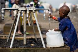On 12 December, a small child fills a collapsible jerrycan with safe water at one of several outdoor taps in a Kibati camp for the displaced, near Goma, capital of North Kivu Province. UNICEF is working with the NGO Mercy Corps to distribute water via truck to tens of thousands of displaced people in Kibati and elsewhere. They are also providing water bladders and installing water pipes, as well as constructing latrines and promoting other hygiene interventions to prevent the outeak and spread of disease.  By 15 December 2008 in the Democratic Republic of Congo, ongoing fighting between government and rebel forces in eastern North Kivu Province continued to threaten local populations and hinder relief efforts. More than 250,000 people are on the move, including more than 60,000 in camps for the newly displaced in the Kibati area, north of Goma, the provincial capital. Over 1 million people in the province are now displaced, with others fleeing across borders to Uganda and Rwanda. Malnutrition rates and hygiene-related diseases, especially diarrhoea and including cholera, are increasing; children are being recruited or re-recruited into armed groups; and hundreds of others have been separated from their families as they flee outeaks of violence. UNICEF is calling for a cessation to fighting and to the recruitment of child soldiers, as well as for safe access to all vulnerable groups. UNICEF is also working to: provide safe water to camps for the displaced; build latrines to help prevent disease outeaks; supply health centres; support measles immunizations; distribute basic non-food items; and support efforts to reunite children separated from their families. Partners include the Government and major donor countries; other UN agencies; and international NGOs, including Solidarité Internationale, International Medical Corps, the International Rescue Committee, Mercy Corps and Save the Children UK. UNICEF has requested US $12 million in additional emergency funding to cover immediate needs for three months. Since 1998, an estimated 5 million Congolese, half of them children, have died of conflict-related causes, including disease; an additional 1,200 people die daily from these causes. Life expectancy in the country is 46 years, and 4 million children are orphaned.