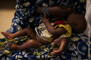 On 13 March, Aissatou Soumaiga eastfeeds 8-month-old Amadou Harouna in the hospital in the conflict-affected city of Gao, capital of the north-eastern Gao Region. Amadou is being treated for severe malnutrition and resulting kwashiorkor, which is characterized by oedema and a loss of appetite. In mid-March 2013 in Mali, renewed insecurity in central and northern parts of the country continues to exacerbate existing humanitarian needs. An estimated 270,765 people are displaced, while 176,777 continue to seek refuge in neighbouring countries. Additionally, Mali remains one of eight countries in the Sahel region  also including Burkina Faso, Chad, Mauritania, Niger and the northern parts of Cameroon, Nigeria and Senegal  facing a severe food and nutrition crisis. The emergency is the result of repeated drought-related food shortages, from which people have had insufficient time to recover before being again affected. Conditions have improved since the height of the crisis in early 2012. Still, an estimated 10.3 million people throughout the Sahel remain food insecure. In Mali, the pairing of food shortages with conflict has left children increasingly vulnerable: 210,000 children under age 5 are at risk of severe acute malnutrition, and 450,000 are at risk of moderate acute malnutrition. Limited access to basic services, including water, sanitation and hygiene, is another key concern. Additionally, some 200,000 children from conflict-affected areas are at risk of injury or death due to explosive remnants of war. Despite the reopening of some schools, access to education remains severely constricted. To respond to these and other needs throughout the year, UNICEF, together with multiple humanitarian partners, including other United Nations agencies as well as NGOs, have called for over US$370 million in the 2013 Consolidated Appeal for Mali. (UNICEFs portion of the Appeal is approximately US$84.7 million.) Only 15 per cent of the Appeal has been funded to date.