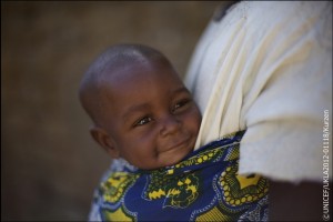 Niger, November 2012. Haouaou Abdou, 52, mother of 6 children is carries her youngest son, is Issiakou, 8 months, in the village of Mazadou Abdou.   By Jessica Mony  In 2011, droughts across the Sahel plunged millions of families into a food crisis. A year after UNICEF and partners emergency response began, we ask ourselves how can we stop this vulnerability and persistent cycle of suffering? A poor, rural Nigerien village 600 people may hold the answer. Here, despite every familys struggle during the drought, no child suffered malnutrition in 2012.  Just three years ago it was rare for a week to go by without a child dying from combinations of malnutrition, diarrhoea and malaria in Mazadou Abdou village. During the frequent droughts, at times this would rise to two or three. No family was spared the pain of loss and mourning. Haouoau and Loli Abdou are just one set of parents that faced this tragedy. Loli holds up three fingers and lists that in 2000, 2002 and then again in 2004 they lost three children to malaria. Looking solemnly at their healthy 8 month baby boy Issiakou, it is clear the scars will likely never heal for this family. Sadly, their situation is not unique in this or any other village across the Sahel.  Fortunately, in 2008 a simple UNICEF programme of family practices helped change all of this. The practices are simple and include exclusive eastfeeding for the first six months of life; complementary feeding for children after six months; proper hand-washing techniques; treatment of diarrhoea; knowledge of how to seek medical care; immunisation; using mosquito nets to prevent malaria; promotion of delayed pregnancies and girls education. The results of adhering to these practices for the children of Mazadou Abdou have been significant. Moutari Louali, a community volunteer who is helping to implement the programme explains the impact. Before the programme started, around four to five children would die every month from malaria, diarrhoea and other diseases. Now, during the whole of this year only three children died, and this was because of miscarriages. From the chief through to parents and children themselves, the whole village is determined that no child should die from preventable diseases. Haouaou is clearly proud of the result In this village we didnt have any malnutrition because we take care of our children. I am very happy about how healthy our children are.   At the heart of the programme are volunteers like Moutari who, along with two other volunteers selected by the community, ensure that every family implements the practices and monitors progress. Every week the group visit up to five families to run information sessions. Today, Moutari is visiting Hoauoaus household. Starting with an update on the health of their children, Moutari then calls a mother and her child forward to demonstrate a particular practice. Today its the use of mosquito nets and hand washing. Everyone here comes to listen and learn. Haouaou points at two of her daughters who were born before and after the programme started and she learnt about the benefits of exclusive eastfeeding. Look you can see this one is much stronger. Whilst drought, hunger and vulnerability are an ongoing reality for these families, their efforts to implement the programme are the key to ensuring their children not only survive, but are resilient through times of drought and extreme hardship.   Issa Iahim the 63 year old chief of Mazadou Abdou describes the precarious situation many families across the Sahel live in. In this village our life is based around farming. The difficulty of this life is that if the rainy season doesnt give a good harvest, life becomes extremely difficult for us. For now the health of their children is safe, but the challenges ahead for the village are immense. A community run cereal bank will help tide them over for a while, but after this the only other option for many families is for husbands and fathers to head to Nigeria to search for work. Haouaou has thirty bowls of millet to feed her family until the harvest a year away. It will only last a month. She holds out the bowl and laughs nervously. What can we do?    Whilst Mazadou Abdous families continue to walk a tightrope of vulnerability, their newfound knowledge will keep their children alive and healthy. It is not the whole solution, but it provides the hope of a future for their most precious resource, their children. The Chief is thankful for how far they have come. We are very proud and happy for what we have done here. We thank God, we thank the people who taught us these practices, but he is also conscious of the toll of chronic hunger on the future of this community; If a man is hungry he cannot hear, he cannot learn anything.  The impact of the emergency response across the Sahel can be seen in the short term in the lives saved and the malnutrition prevented. For vulnerable families like Haouaous though, building resilience and food security will be key to long term change. This village has demonstrated the success of community driven initiatives to improve childrens health, but more support is needed to ensure communities across the Sahel are able to withstand crises. Haouaou tries not to think about what might happen a year from now; Nobody can forsee the future. Even if we wait and hope for the best, anything can happen at any moment.  UK Natcom - for local copies of the files: Y:Key-initiativesIFSahel-Stories-2012Niger