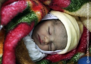 An infant sleeps under a blanket in a baby-friendly hospital in the port city of Latakia in the western Latakia Governorate. The Baby-Friendly Hospital Initiative (BFHI), a global campaign led by the World Health Organization and UNICEF and endorsed by world leaders and health experts, encourages hospitals and health workers to support mothers' efforts to eastfeed. In April 2006, the Syrian Arab Republic has made considerable progress towards improving the situation of children and women and is on track to achieve almost all Millennium Development Goals. The country has high immunization coverage rates; infant, under-five and maternal mortality rates have declined; overall primary-school enrolment rates are above 90 per cent; and HIV/AIDS prevalence is low. Nevertheless challenges remain, including for refugees, children with disabilities and children in conflict with the law. Due to long working hours, tens of thousands of children nationwide are not in school. Gender and geographic disparities persist, including in education, and are wider in the five northern and north-eastern governorates, home to half of Syria's 18.6 million inhabitants. Political instability in the region, high unemployment and other economic factors also affect the country's overall development. UNICEF supports health, education, water and sanitation and child protection initiatives, HIV/AIDS awareness and prevention programmes for adolescents and young people, and educational projects for children with special needs. UNICEF is also supporting policy and legislative initiatives to protect and promote children's rights.