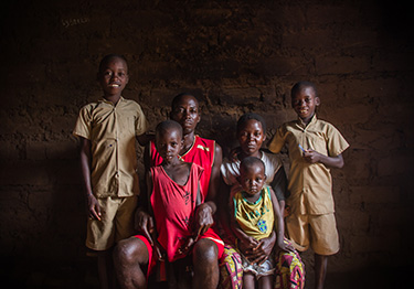 © UNICEF Burundi/2016/Haro Aimable and his family. After seven years of living on the streets with his other, the Kabondo Football for Hope Centre helped him return home.